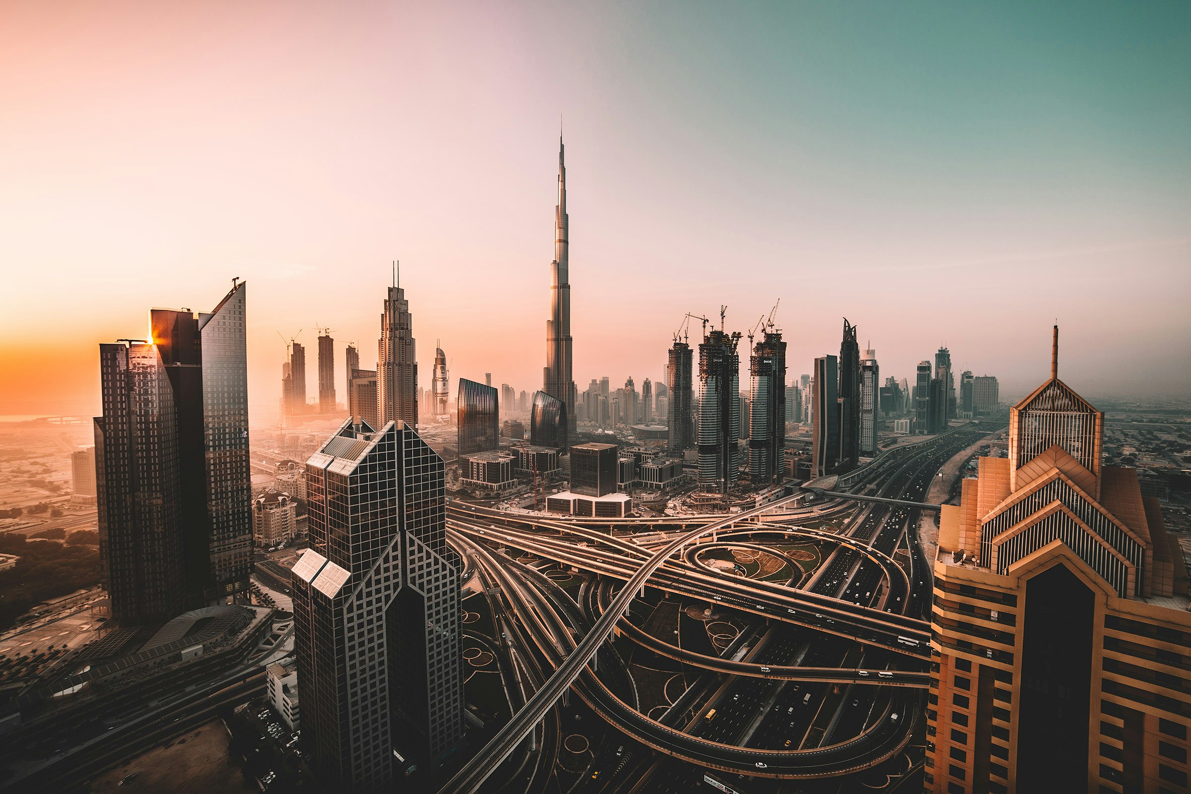 Downtown Dubai and the Burj Khalifa at dusk — the city is already moving