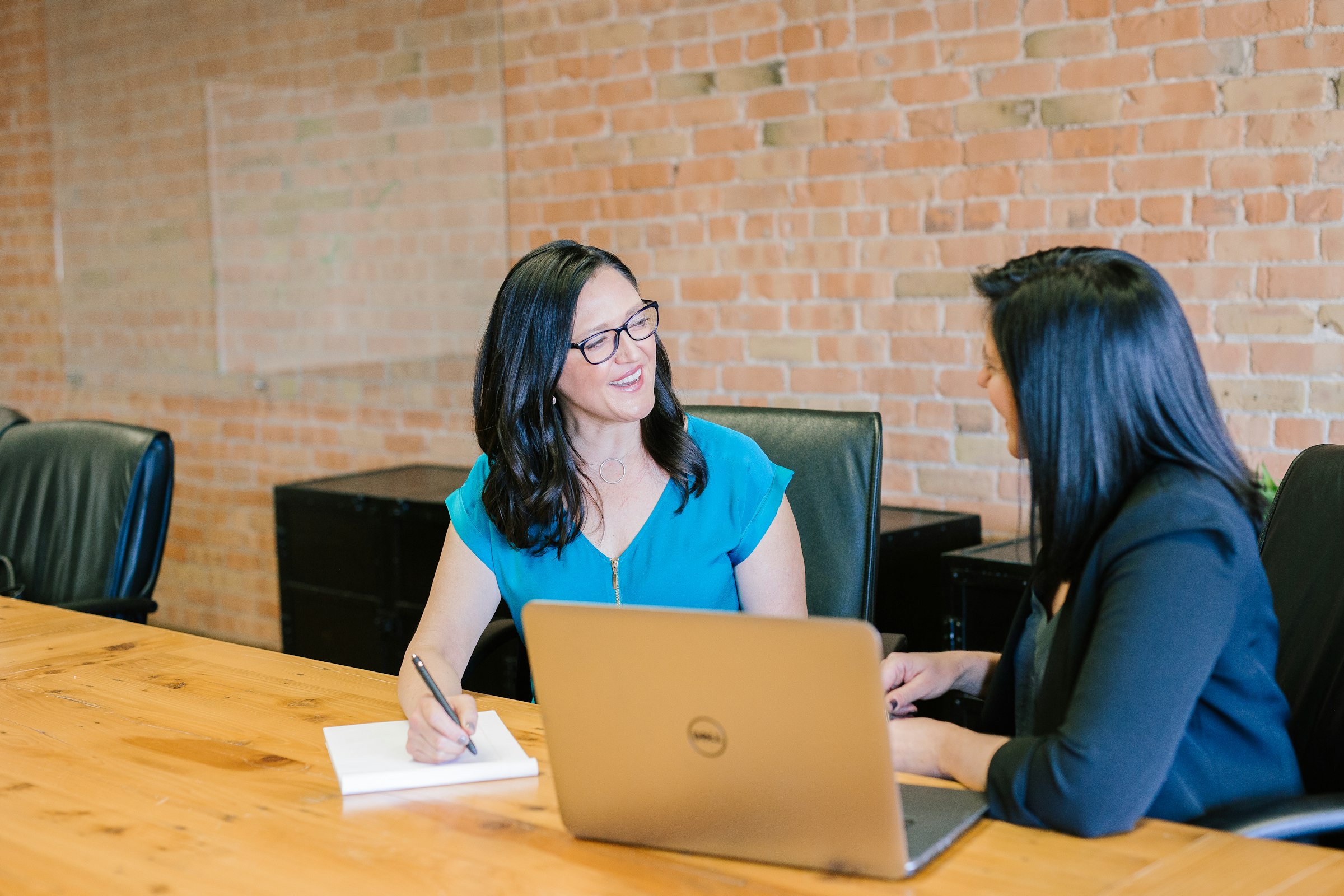 Two colleagues in a private conversation — alignment happens here, before anything reaches a formal meeting